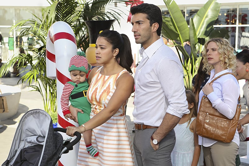 Gina Rodriguez as Jane and Justin Baldoni as Rafael stand in line to meet Santa.