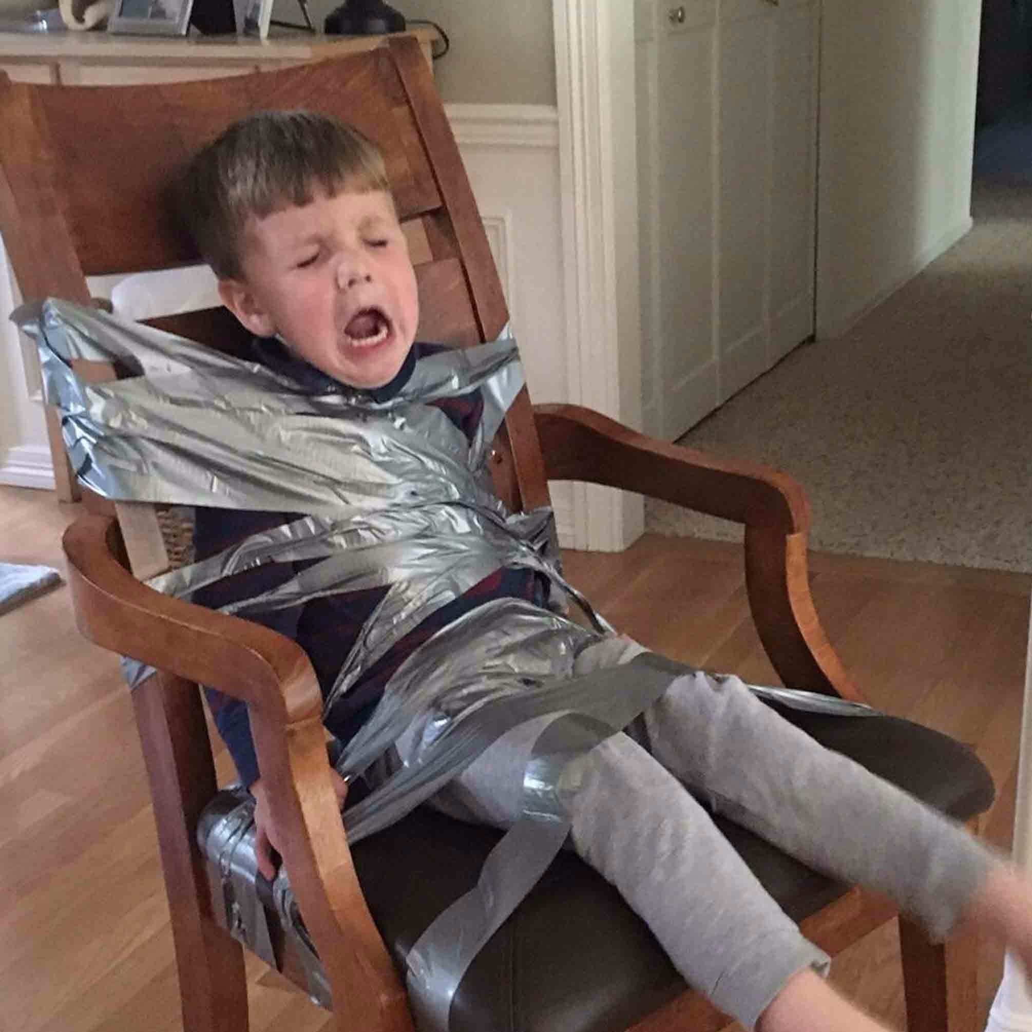 Kid Duct Taped To Wall