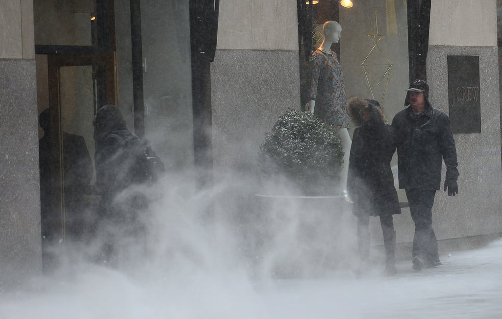 Snow blew along the sidewalk in NYC.