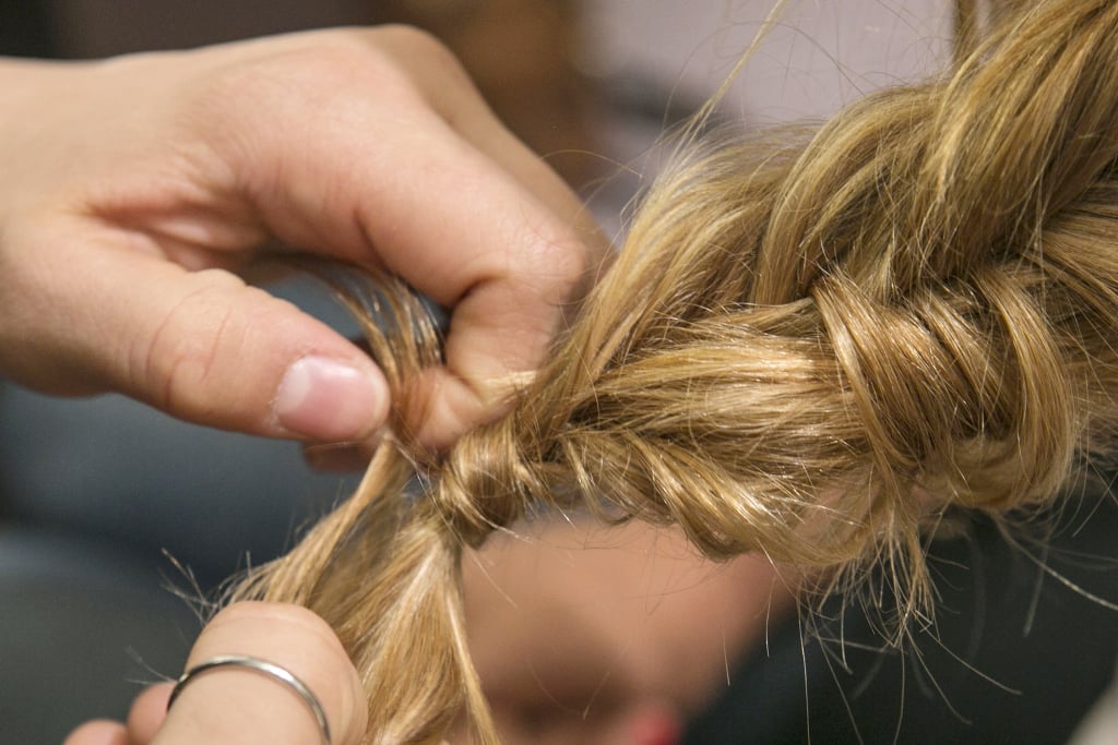 If you want to get a little fancy, before you completely secure the elastic, wrap a section of hair around the elastic before pulling the hair through the final loop of the band.