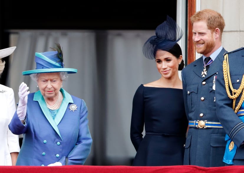 LONDON, UNITED KINGDOM - JULY 10: (EMBARGOED FOR PUBLICATION IN UK NEWSPAPERS UNTIL 24 HOURS AFTER CREATE DATE AND TIME) Queen Elizabeth II, Meghan, Duchess of Sussex and Prince Harry, Duke of Sussex watch a flypast to mark the centenary of the Royal Air 
