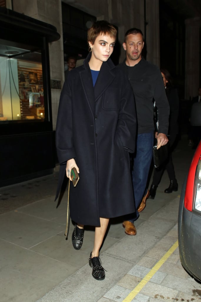 Cara Delevingne stayed incognito in dark separates while out in London.