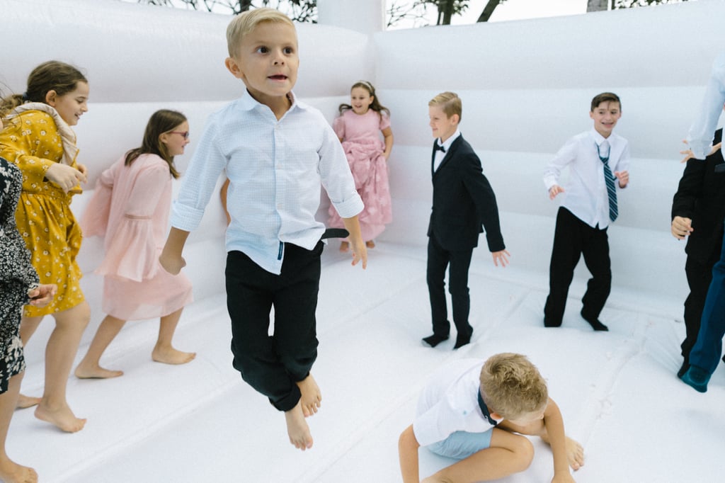 Couple Takes Wedding Photos in Bouncy Castle