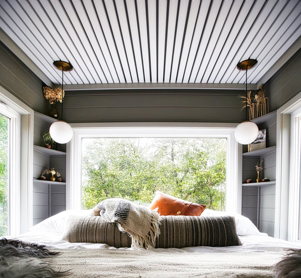 Timeless mounted lighting means no end tables are necessary and a gigantic bay window really pulls in the light in the master bedroom. The Fishbeyns added corner shelves for even more storage.