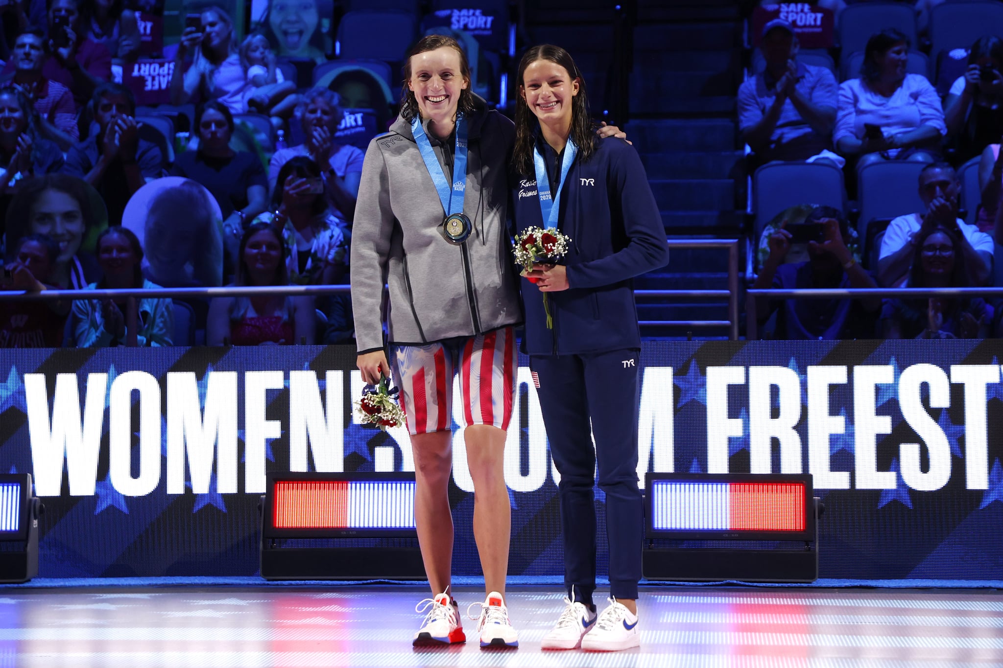 OMAHA, NEBRASKA - JUNE 19: Katie Ledecky and Katie Grimes react during the Women's 800m freestyle medal ceremony during Day Seven of the 2021 U.S. Olympic Team Swimming Trials at CHI Health Center on June 19, 2021 in Omaha, Nebraska. (Photo by Al Bello/Getty Images)