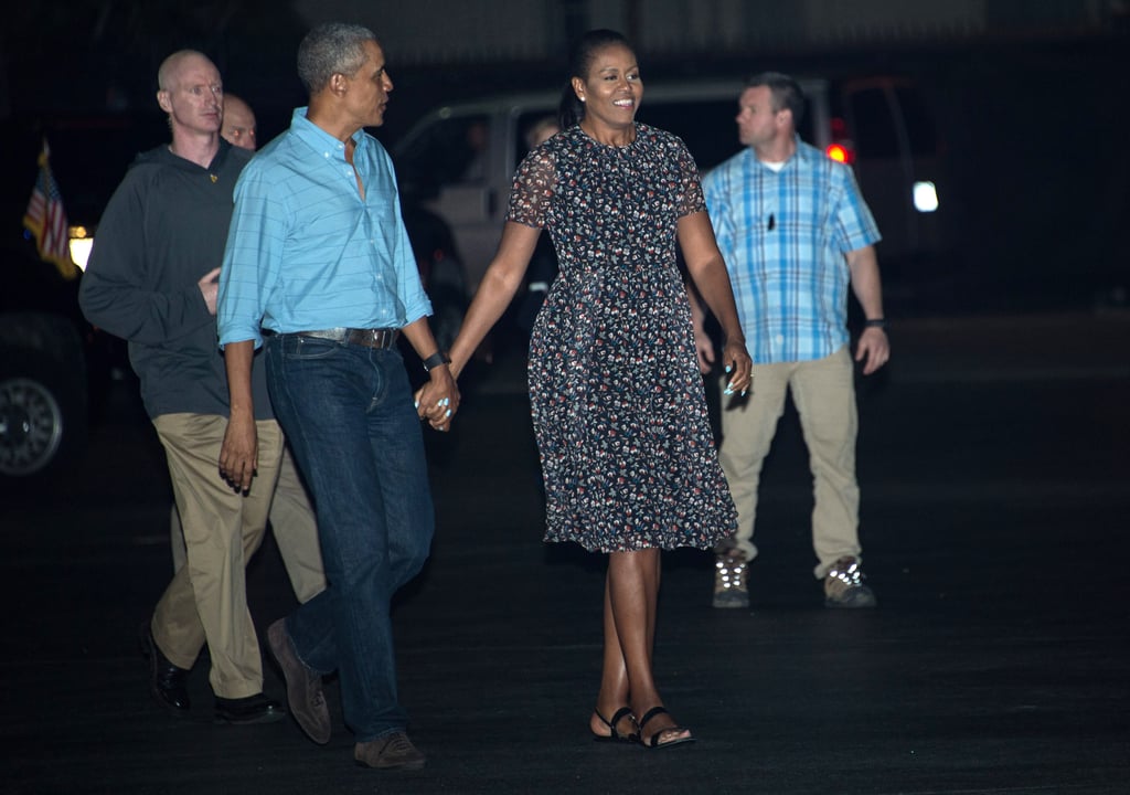 Michelle wearing a floral chiffon dress leaving Honolulu.