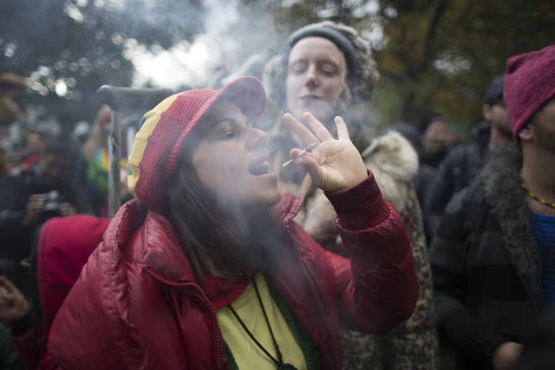 (FILES) In this file photo taken on October 17, 2018, a woman smokes a marijuana cigarette during a legalization party at Trinity Bellwoods Park in Toronto, Ontario. - Canada's health ministry warns parents against consuming cannabis because of the risks 