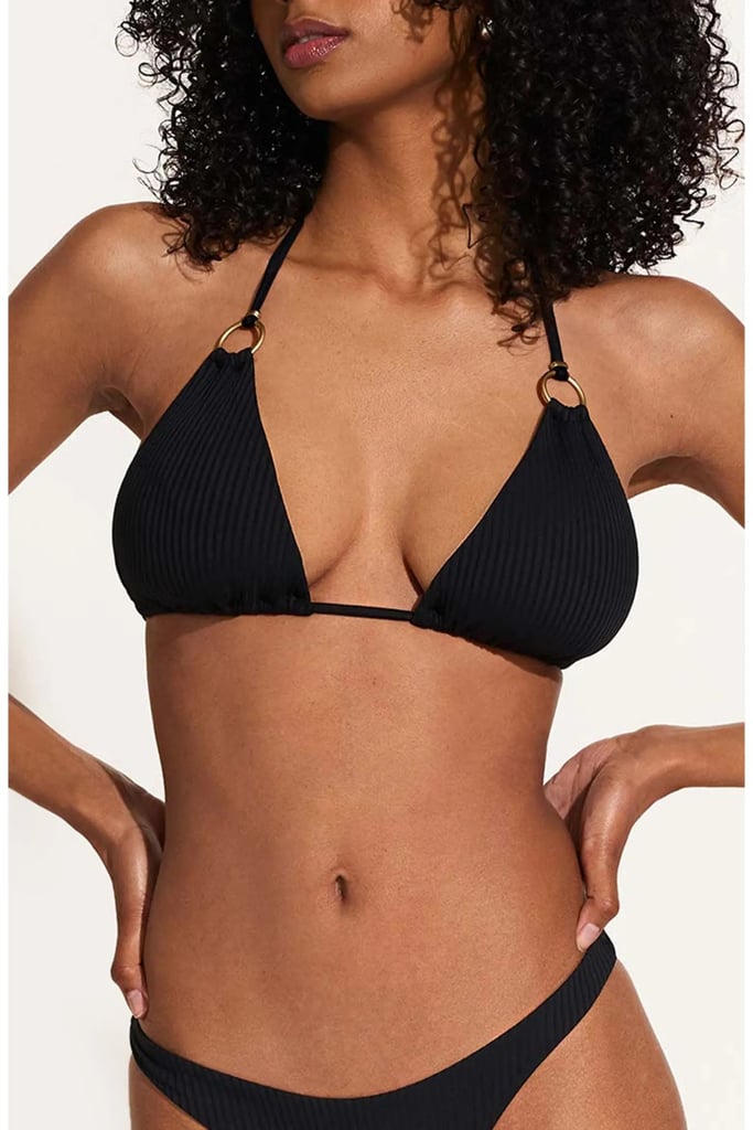 Vitamin A Cosmo Rib Bikini Top ($100)
When people talk about swimsuit basics I immediately think of a classic black triangle top. I've worn this ribbed bikini for two summers in a row and consider it one of my go-to pieces. The subtle gold rings add a bit of personality to the traditional style, while the color and design easily match any bottom.