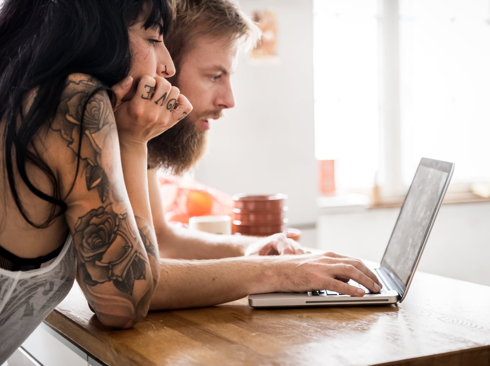 Young Couple Looking at Laptop