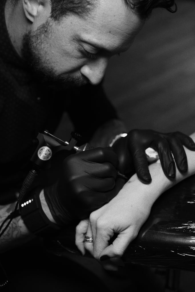 Once he inked Cyrus, the celebrity requests started pouring in. Soon enough, his art was on Mandy Moore, Demi Lovato, Chrissy Teigen, Joe Jonas, Sophie Turner, and more. Now, it's hard to find a tattoo-loving celebrity in California whom Winter hasn't inked, but he likes to remind everyone that the celebrity clientele is only one percent of his total business. "The other 99 percent of my clientele, which is normal people, is what makes my business kind of go around," Winter said. 
It's easy to spot Winter's tattoos on Instagram — they're incredibly clean and precise; a true work of art. He likes to look at artists like Matisse, Picasso, and Salvador Dali. "When you look at Picasso, his stuff is so simple, but it has such an impact," Winter said. "So I try to kind of mimic my style toward that minimalistic vibe."
But his main source of inspiration is his clients, and he prides himself on giving an extremely personal tattoo experience. "You come in, we sit down, we have a conversation, and we go over what you're thinking," Winter said. "Ninety-nine percent of the tattoos that people are getting in my studio are extremely meaningful."
Being completely self-taught, he can't give credit to any one mentor for helping him get to where he is; he was a "lone wolf" when he started out. "The tattoo industry 10 years ago was very different from what it is today," Winter said. "It was very, very strict in the sense where now it's more like artists giving tattoos instead of just picking a piece of flash off the wall."