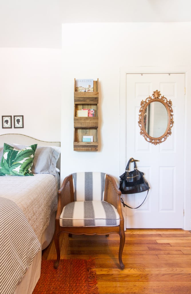 With no room for a nightstand, Marissa placed an upholstered chair next to the bed instead. It anchors the bed while providing additional seating and a short-term place to hold items. A mounted hanging rack, like the one here, is perfect for longer-term storage for books and mail.