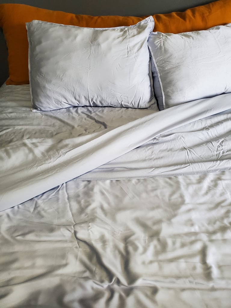 Quince Bamboo Sheet Set in Sky Blue ($100-$154)
"My partner sleeps hot and I'm always cold, so finding sheets that work for both of us is quite the challenge. These organic bamboo sheets from Quince work for both of us, and we're big fans. 
These sheets are unbelievably soft — they make me excited to crawl into bed every night. The silky smooth sateen weave is cool to the touch and regulates your temperature, which makes these sheets perfect for summer. Bamboo is also naturally hypoallergenic, so you'll get the best rest possible even at the height of allergy season.
The only downside to these sheets is that they are wrinkly. I personally don't mind, but if you want a picture-perfect dreamy bedroom, you'll need to air dry them or break out the steamer after every wash." — Lauren Murphy, former SEO coordinator
Rating: