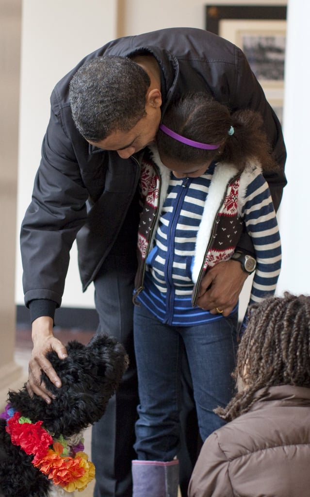 Look at how little Sasha was! She, Barack, and Malia gave Bo (rocking a colorful lei, naturally) some love in 2009.