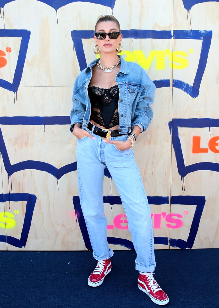 Combining masculine and feminine, Hailey Baldwin wore a vintage Dior corset, a Levi's denim trucker jacket and jeans, a Jack Vartanian chain, her signature Bieber necklace, and red, high-top Vans to the Levi's party. When re-creating this look, don't be afraid to go oversize with your denim and pile on the jewellery.