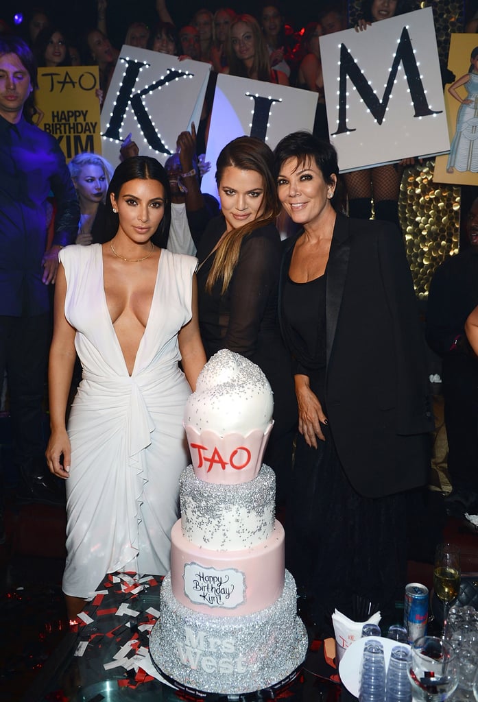 Kim, Khloé, and Kris surrounded the large birthday cake.