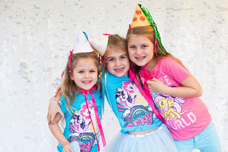 I love having a photo op at parties. Even if you don’t have a photographer, almost everyone has a camera on their phone that they can pull out to grab a photo. Hang a piece of fabric, string some garland or maybe add a bundle of balloons where people can pose with the birthday girl. Photo props are easy to find down almost any party aisle, or make your own! Put out a basket of hats, scarves, sunglasses, and silly accessories and watch your guests go wild! It’s fun to get photos of the guests at the event that you can print and send with thank you cards.