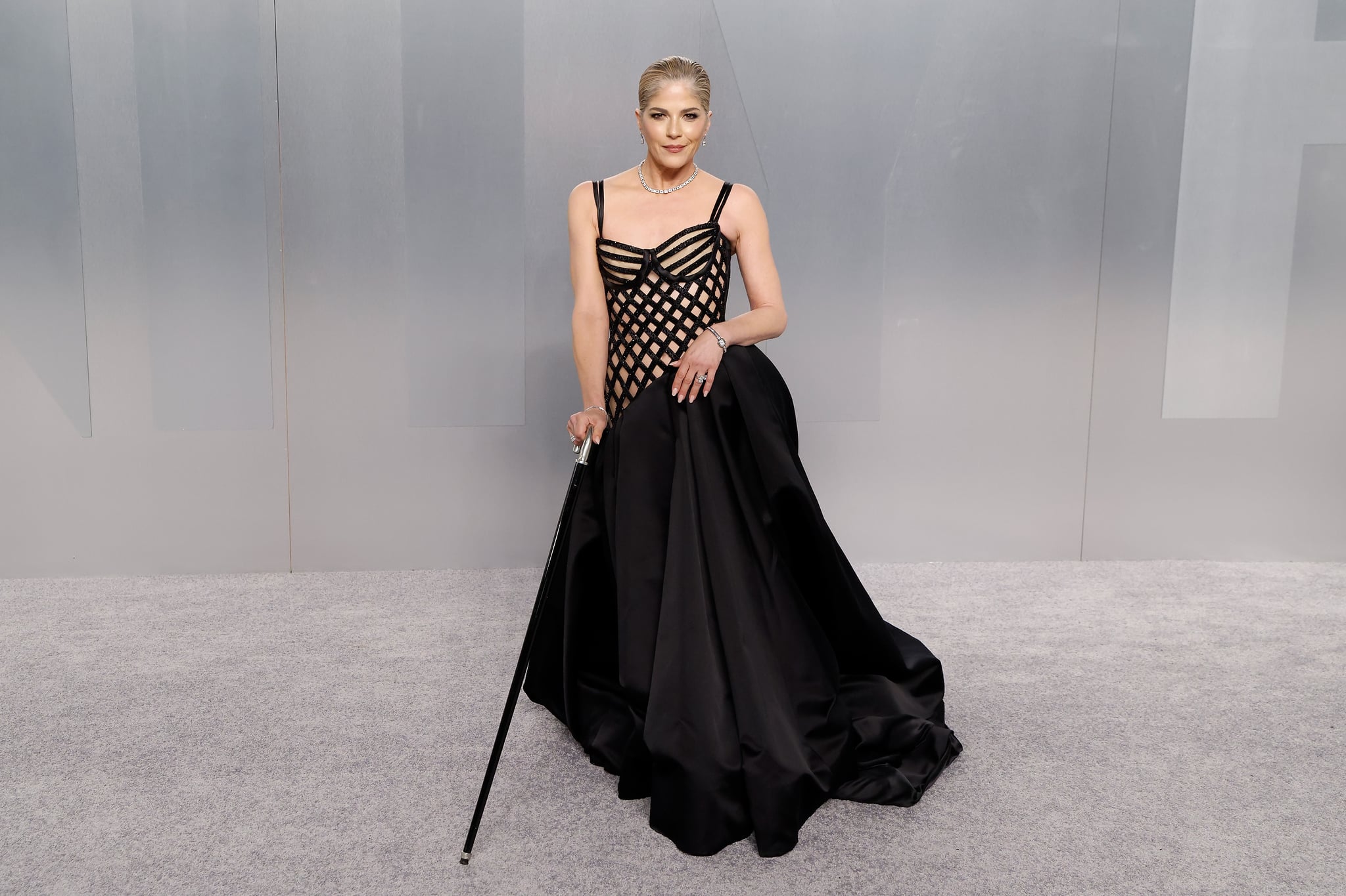 Selma Blair attends the 2026 Vanity Fair Oscar Party wearing black gown and cane.