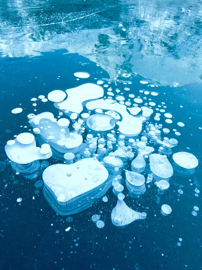 "Some photos defy easy interpretation, like the abstract pattern captured here. The layers of detail present — bubbles, reflections, and moving water — invite viewers to create their own interpretations."