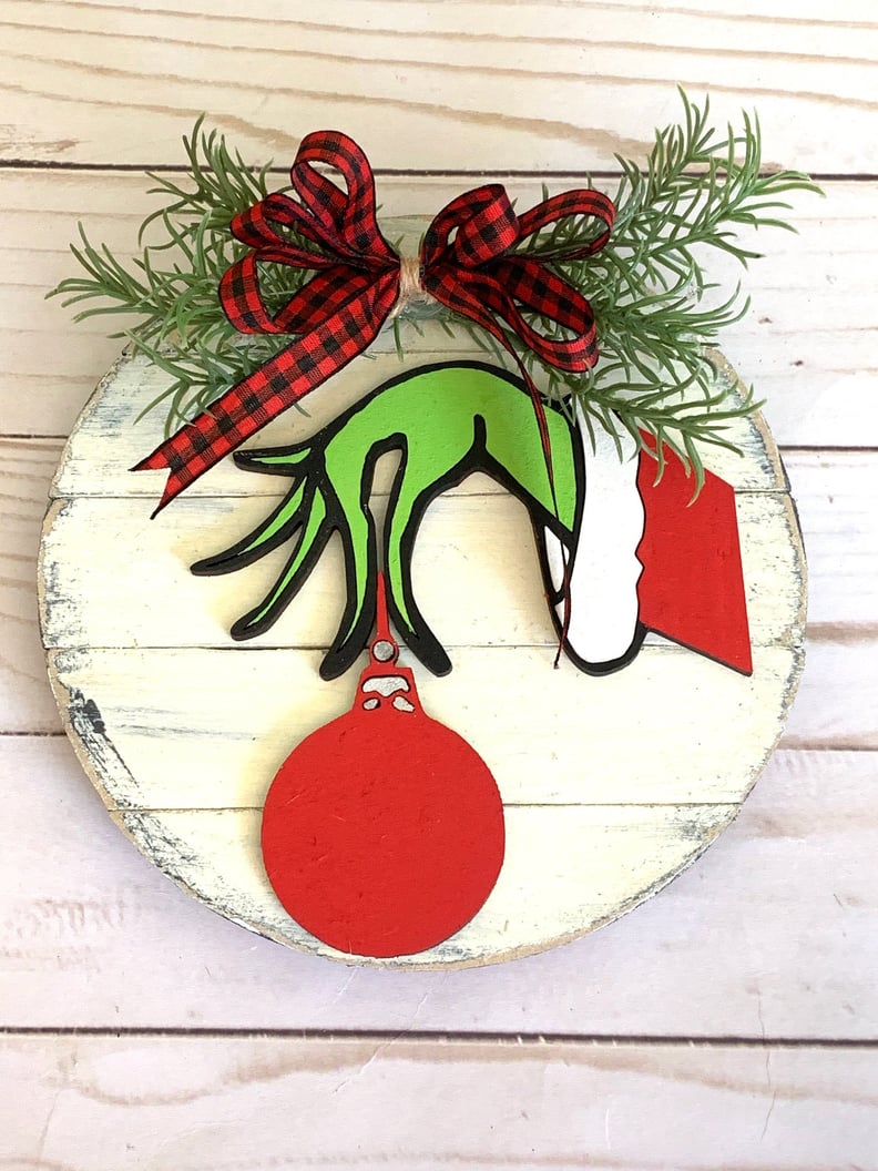 GRINCH STYLE HAND WITH XMAS BAUBLE AND TEXT MERRY CHRISTMAS