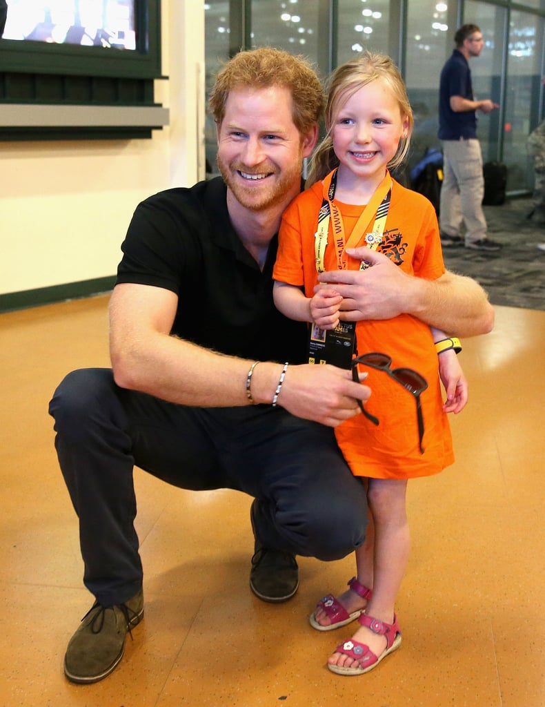 Prince Harry cuddled close to a young fan in Orlando back in May.