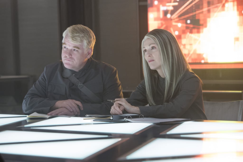 Philip Seymour Hoffman as Plutarch Heavensbee and Moore.