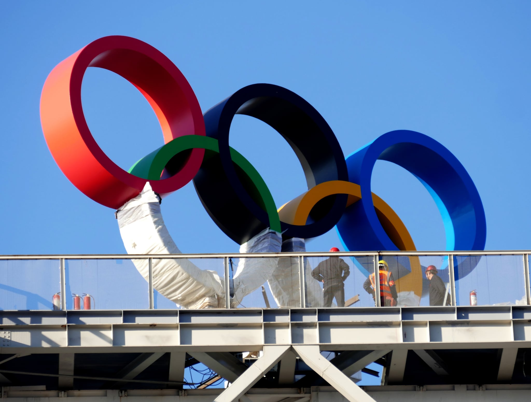 BEIJING, CHINA - OCTOBER 21: Workers install Olympic rings at Shougang Park on October 20, 2021 in Beijing, China. The Big Air Shougang at Shougang Park will host the big air freestyle skiing and snowboarding competitions of the Beijing 2022 Winter Olympic Games. (Photo by Li Wenming/VCG via Getty Images)