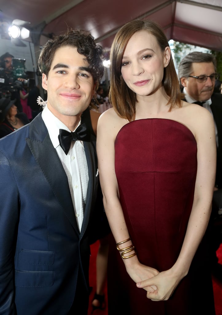Carey smiled next to Darren Criss.