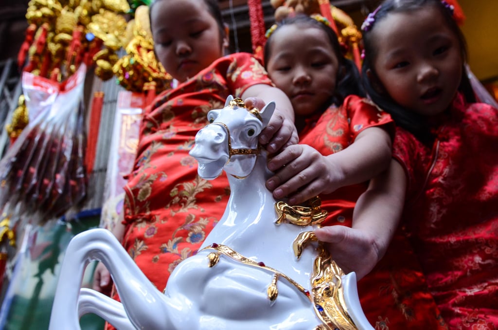 Kids held on to a horse figurine, which symbolized the Year of the Horse, in the Philippines.