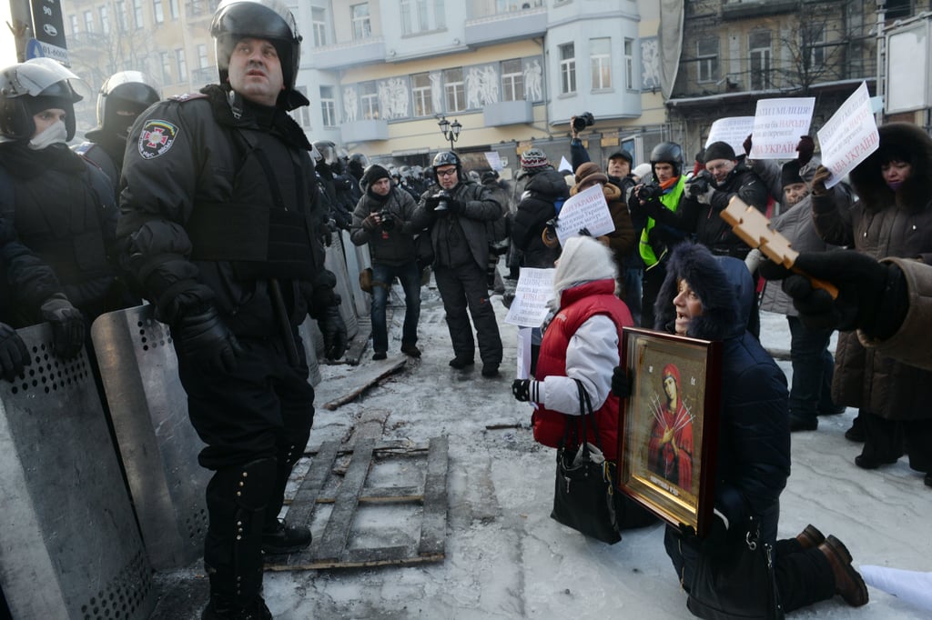 Women grouped together in front of the police.