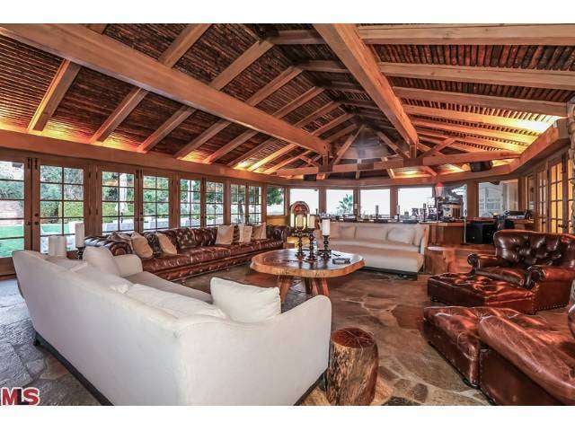 With its stone floors, massive fireplace, and built-in bar, the "Aspen room" functions like a den, easily accommodating large gatherings.