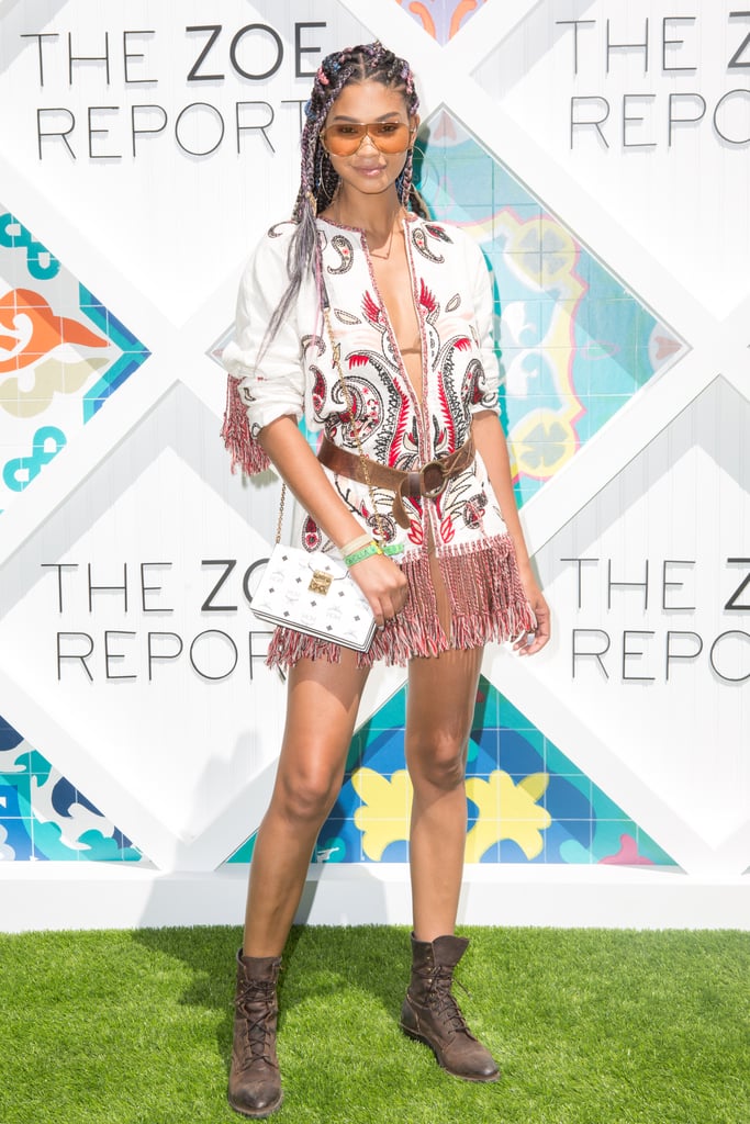 Chanel Iman wearing a fringed tunic and boots at The Zoe Report's Zoeasis party. 