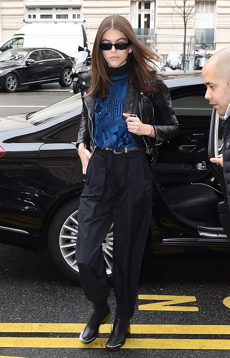 During a Day Off, Kaia Was Spotted in Paris Wearing a Blue Top, Leather Jacket, Black Pants, and Boots
