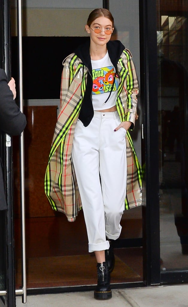 The model rocked an Anna Sui crop top with white jeans and a $2,600 Burberry plaid trench coat.