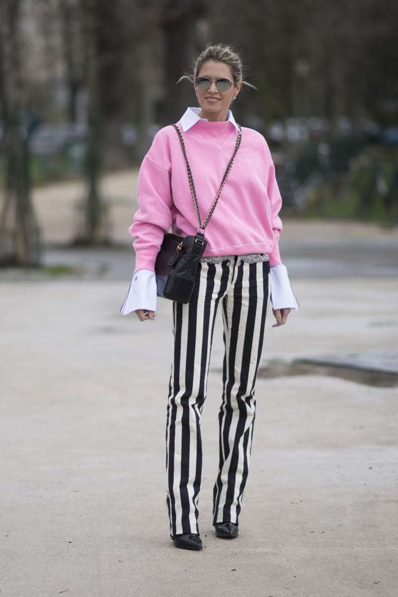 Striped Trousers and a Pink Sweater Worn Over a White Shirt