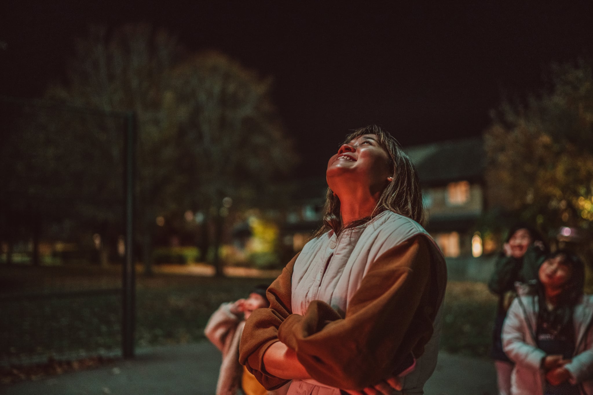Young Woman Outside Looking Up at Sky