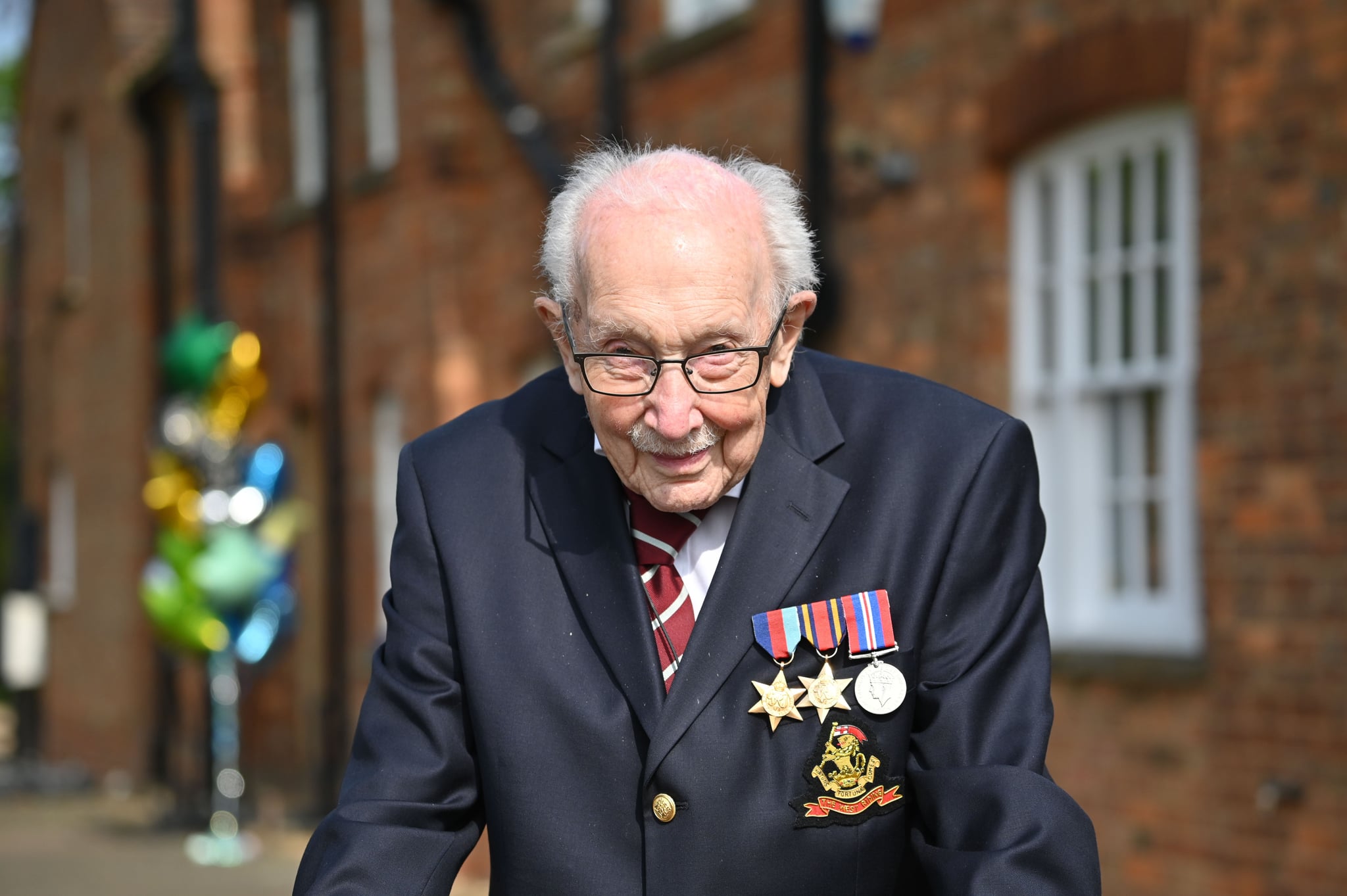 British World War II veteran Captain Tom Moore, 99, poses doing a lap of his garden in the village of Marston Moretaine, 50 miles north of London, on April 16, 2020. - A 99-year-old British World War II veteran Captain Tom Moore on April 16 completed 100 laps of his garden in a fundraising challenge for healthcare staff that has 