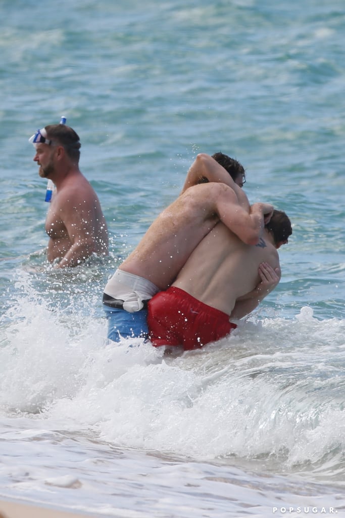 Charlie Hunnam and Garrett Hedlund Wrestle in Hawaii Photos