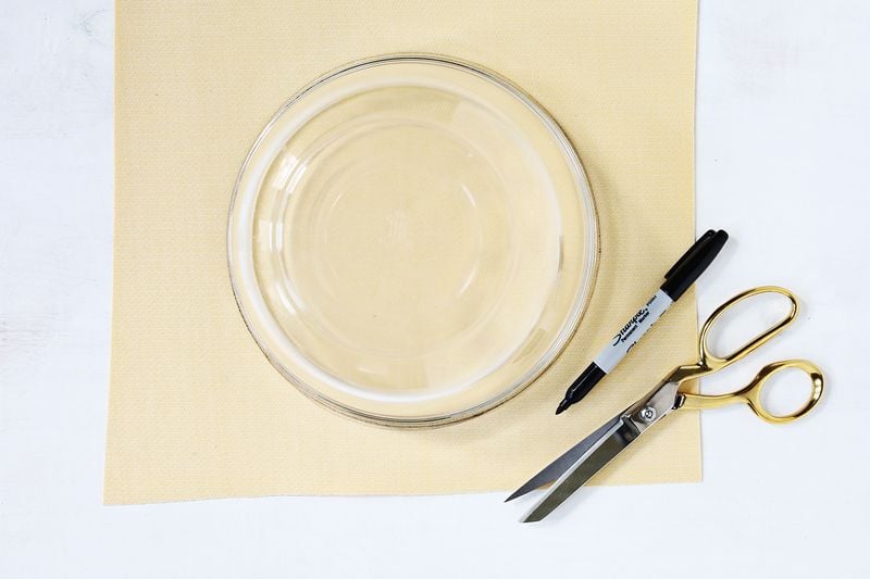 Get your bowl or plate that you're going to use as your face template (shoot for a size of 8-9"). Trace two circles onto the back of your yellow vinyl, and cut out your circles.