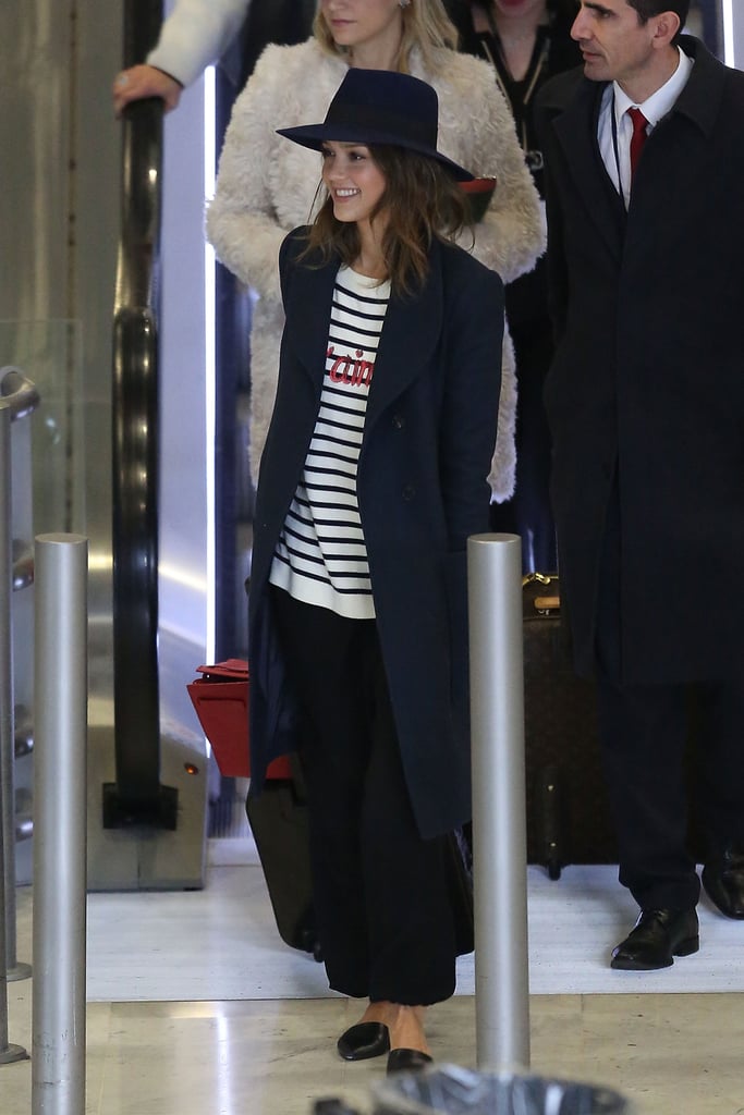 The centerpiece of Jessica Alba's très chic travel style was her striped and sequined "Je T'aime" sweater, which she finished with D'Orsay flats and a classic coat.