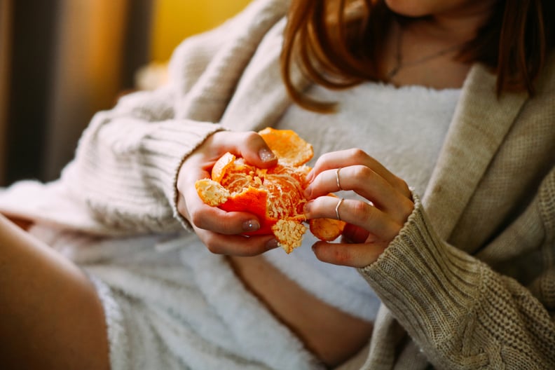 Close-Up of Woman Peeling Orange