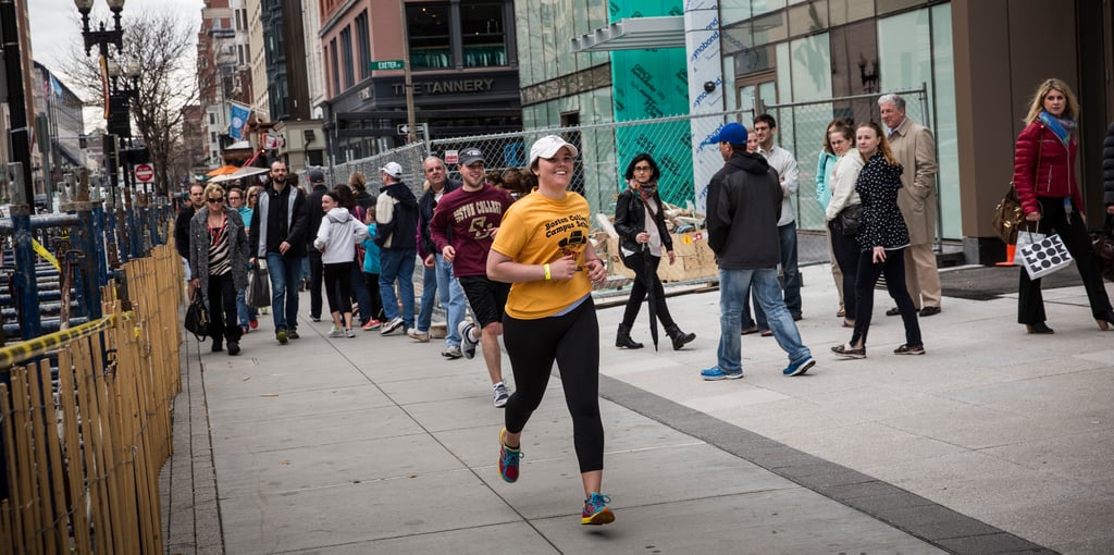 波士顿学院的学生都是微笑他们越过终点线时,在强盗马拉松官方比赛前一个星期。