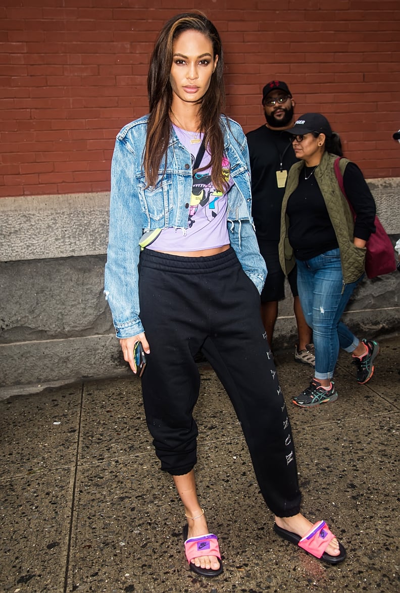 Joan Smalls Left the Escada Show in a Cropped Denim Jacket, Sweatpants, and Pink Slides