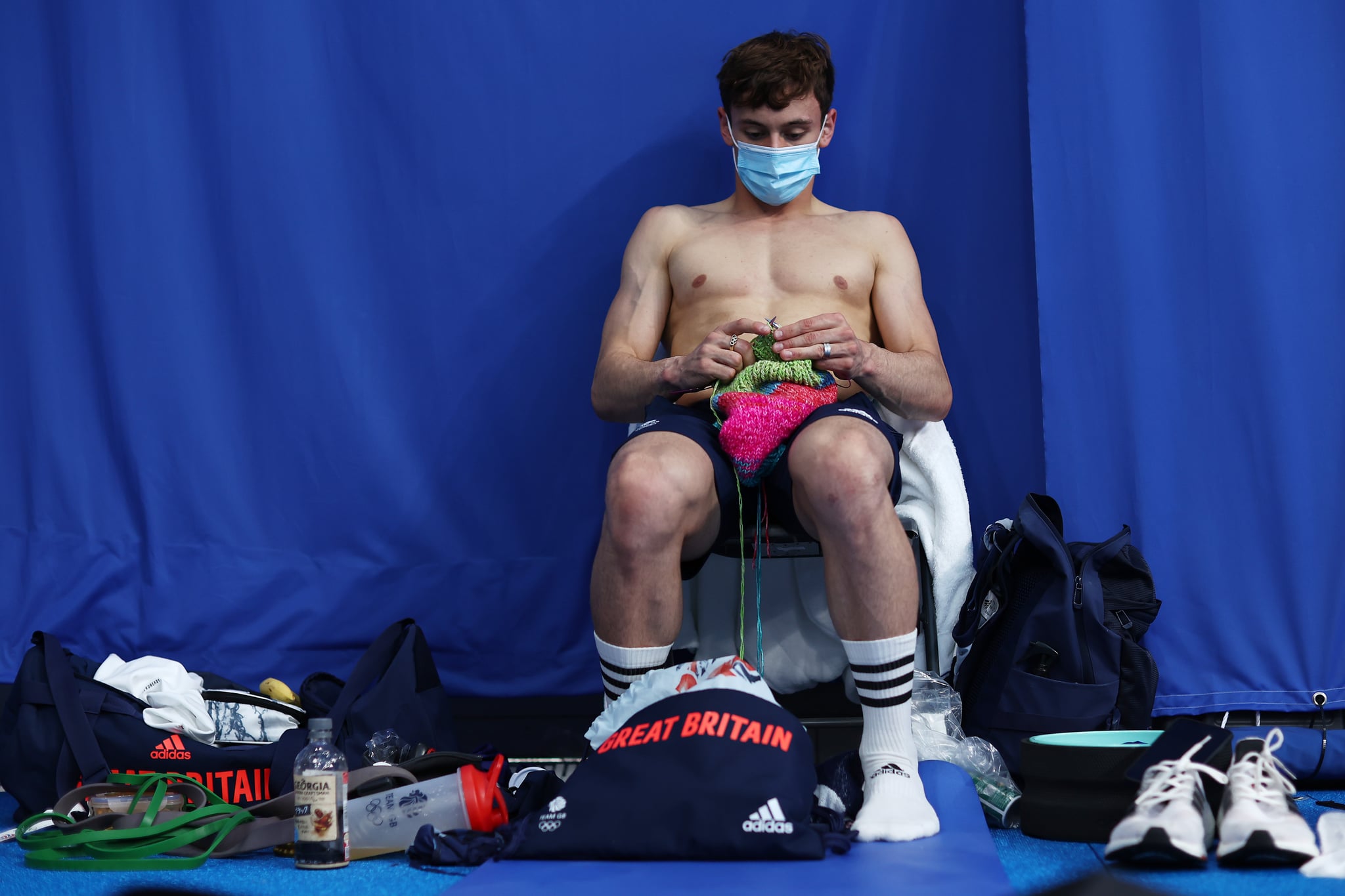 TOKYO, JAPAN - AUGUST 07: Thomas Daley of Team Great Britain is seen knitting before the Men's 10m Platform Final on day fifteen of the Tokyo 2020 Olympic Games at Tokyo Aquatics Centre on August 07, 2021 in Tokyo, Japan. (Photo by Clive Rose/Getty Images)
