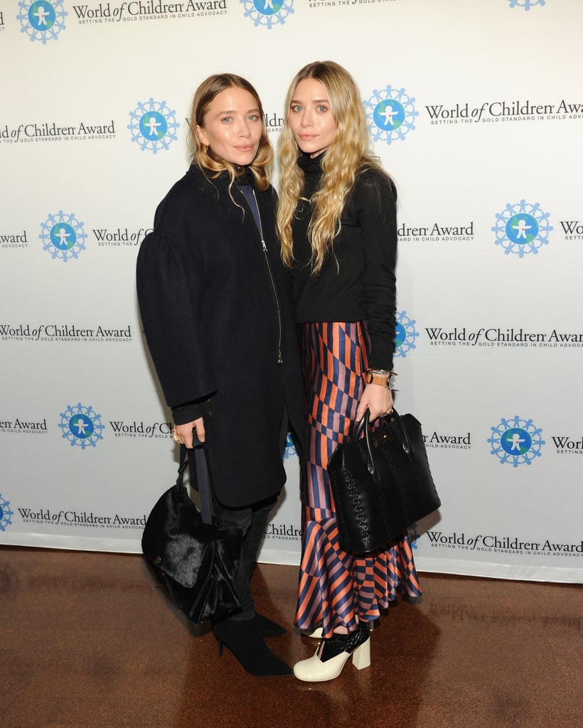 Twinning combo: The high-style sisters showed minimal skin while attending the World of Children Awards in 2014.

Ashley, in an unusual move for the usually monochromatic dresser, went bold in a funky striped skirt.
Mary-Kate pumped up the volume in a cocoon coat.