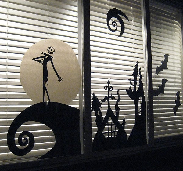 Turn your windows into a scene from The Nightmare Before Christmas using a silhouette machine and a pair of scissors.