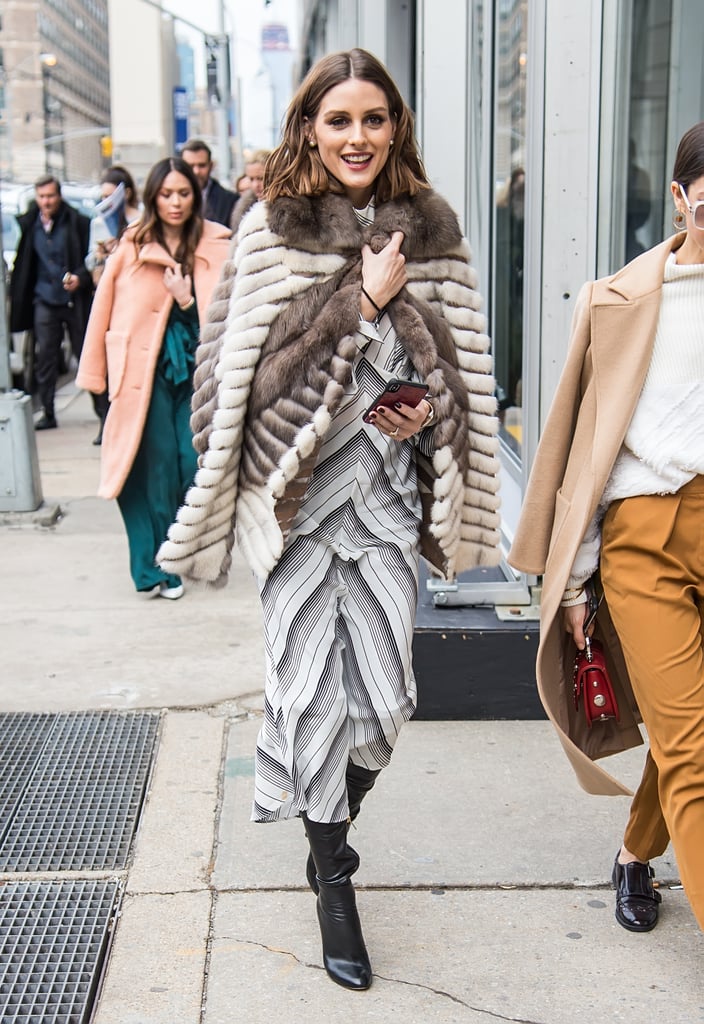 While leaving the Zimmermann show, Olivia snuggled up in a fur jacket that she wore on top of her striped Zimmermann dress.