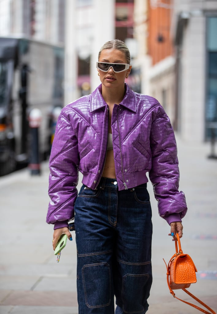 Finishing off denim with a saturated lavender puffer and an orange bag in tow really amps up the look, no?