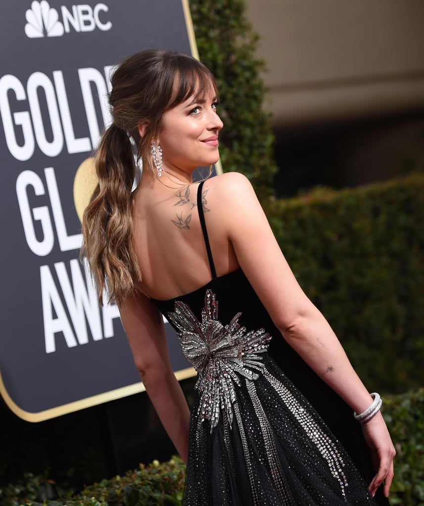 The highlight of Dakota Johnson's Gucci dress was definitely the embellished back. She shone even more with Nirav Modi jewels.