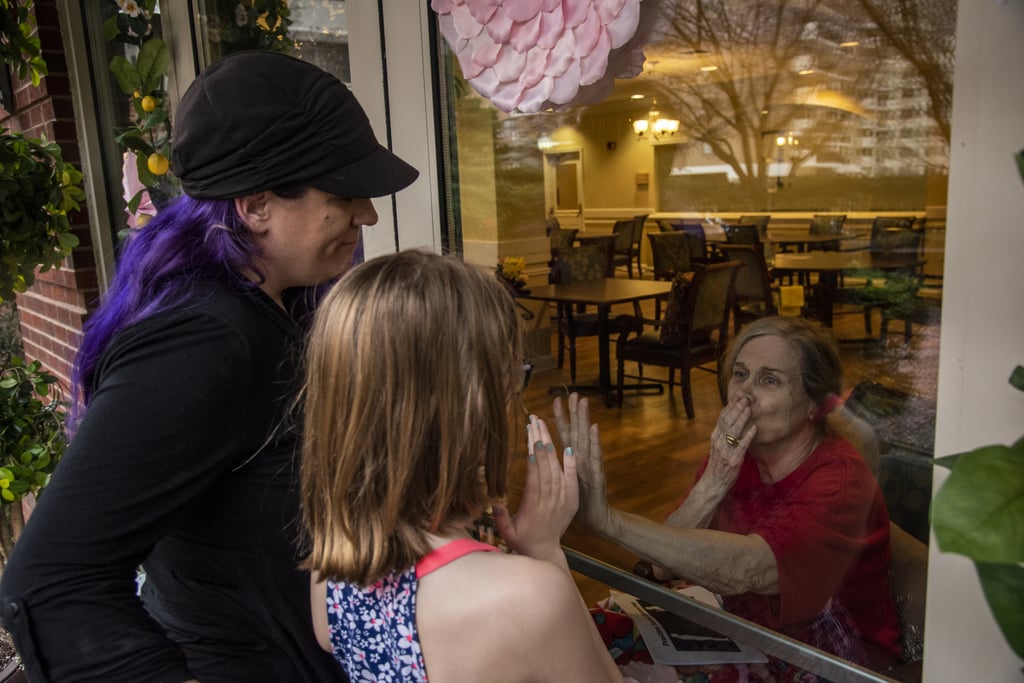 Anna Epstein brought her 9-year-old daughter Riley to visit with her 78-year-old grandmother in a nursing home this past March. This photo was taken as they were saying goodbye after chatting via cellphone through the glass.