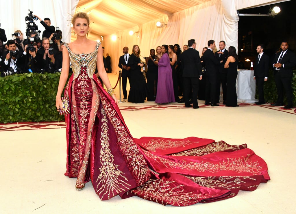 Step 1: Freak out over Blake Lively's insanely glamorous Met Gala gown. Step 2: Take a breather and bask in the gorgeousness that is her regal beauty, and see if you can handle it better than the photographers at the Met Gala could. Step 3: Go on with your day and try to accept that even though Blake Lively didn't bring hubby Ryan Reynolds as her date, she made up for it with every single detail of her outfit being on-theme.  OK, now, take a step back and prepare to have your mind blown, because it turns out that the Met Gala veteran actually did bring Ryan with her, and not only him, she brought the whole family right in the palm of her hand! For the "Heavenly Bodies: Fashion and the Catholic Imagination" theme, Blake carried a custom Judith Leiber handbag emblazoned with a "Reynolds" family crest matching perfectly to her Versace gown.  If you look a little closer you can see the initials B, R, J, and I, for Ryan and their daughters James, 3, and Ines, 1. Yep, it doesn't get any sweeter than that, and we can't believe the subtle family tribute almost slipped right past us. Read on for a closer look at the heartwarming bag. Related: No One&apos;s Met Gala Afterparty Look Shook the Room Like Blake Lively&apos;s â We Promise You That! 